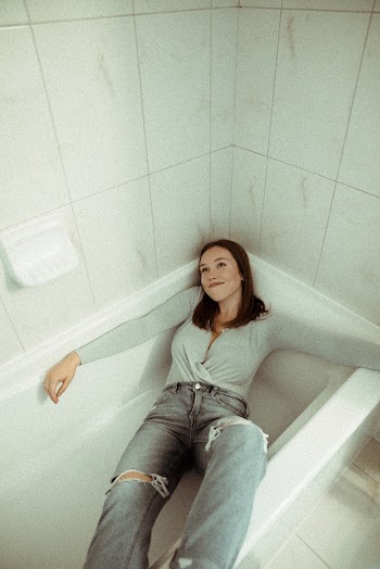 Woman Lying on Bath Tub