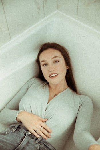 Woman Lying on Bath Tub