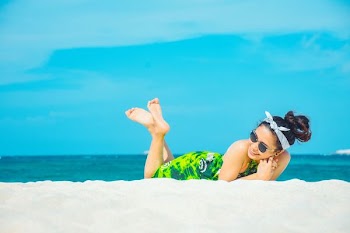 woman lying on beach sands