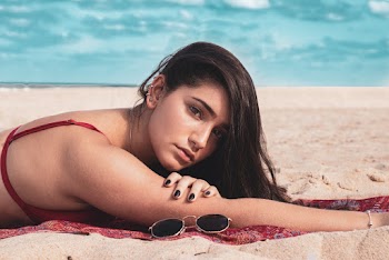 Woman Lying on Beach Shore