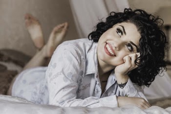 Woman Lying on Bed Looking Up