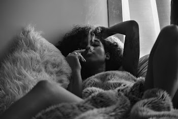 Woman Lying On Bed While Smoking