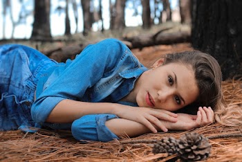 Woman Lying on Brown Leaves Inside Forest