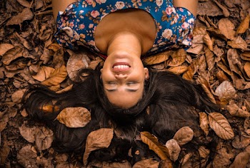 Woman Lying on Dried Leaves