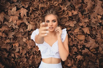Woman Lying On Dry Leaves