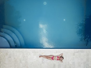 Woman Lying on Floor Near Pool
