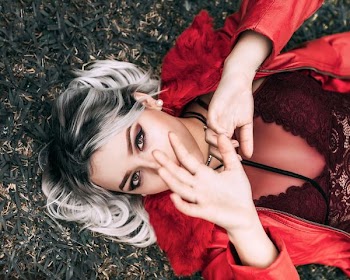 woman lying on grass field