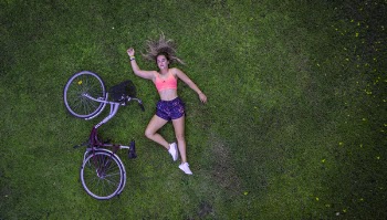 Woman Lying on Grass Field