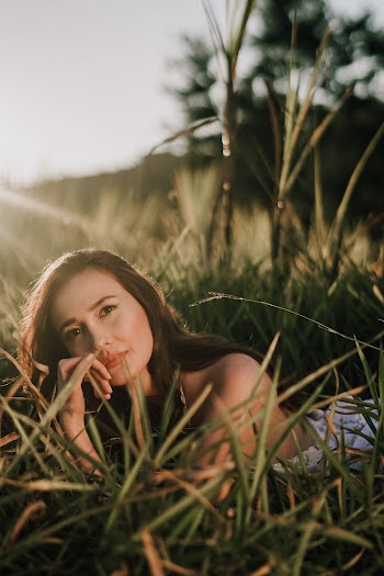 Woman Lying on Green Grass