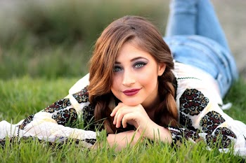 Woman Lying on Green Grass Field during Daytime
