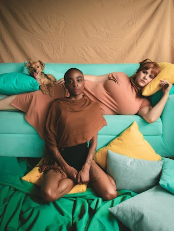 Woman Lying on Green Sofa