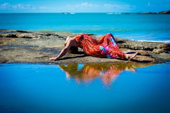 Woman Lying on Ground Near the Bodies of Water