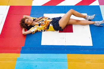 Woman Lying on Multicolored Concrete Pavement 