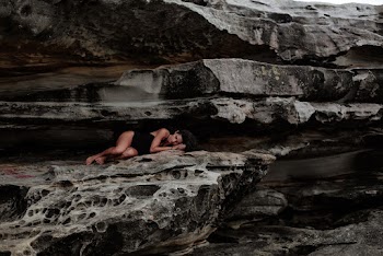 Woman Lying on Rock