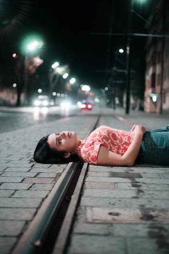 Woman Lying on Sidewalk