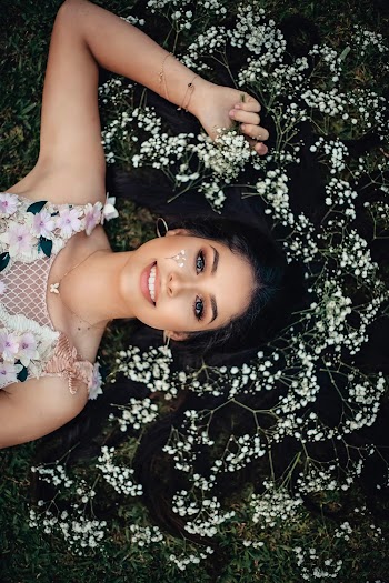 Woman Lying on White Flowers