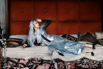 Woman Lying on White Mattress