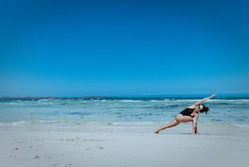 Woman Making Stunt Beside Seashore