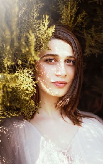 woman near green leafed plants during daytime