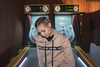 Woman Near Maze Arcade Machine