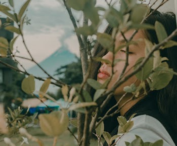 Woman Near Plant on Selective Focus Photo