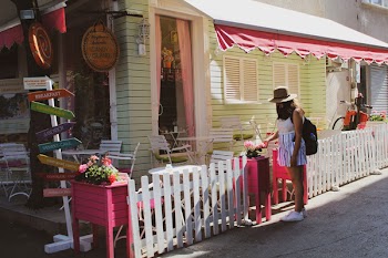 Woman Near to Wooden House and Table and Chair Lot