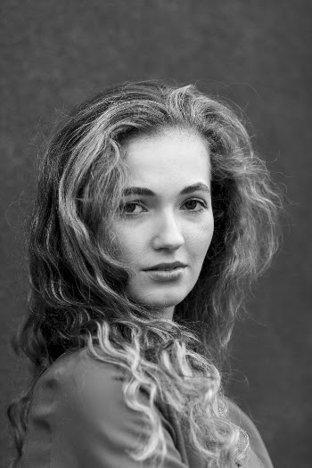 Woman Near Wall Grayscale Photo