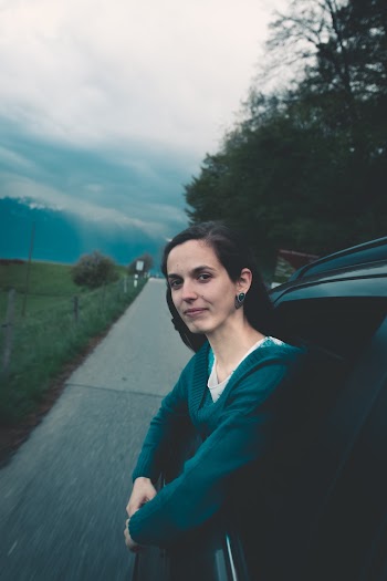 Woman on a Black Vehicle Looking Out the Window