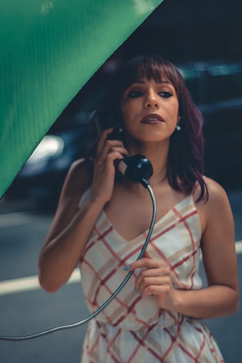 Woman On A Public Payphone