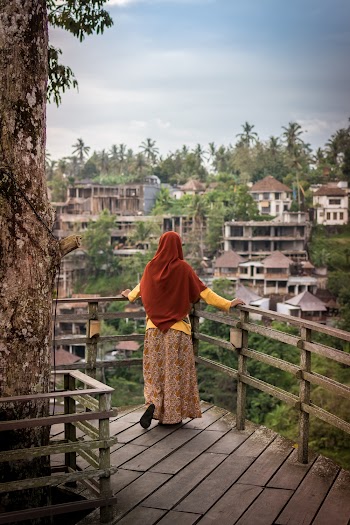 Woman On A View Deck Looking At The Scenery