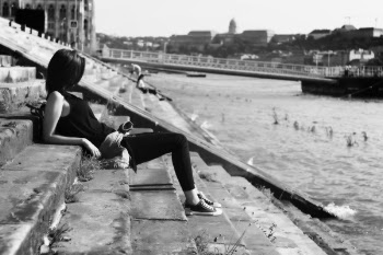 Woman on Black Shirt Sitting on Stairs in Front of River