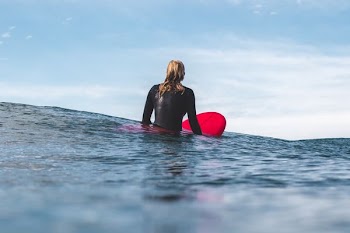 woman on board at beach during daytime