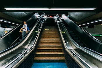 Woman on Escalator in Subway