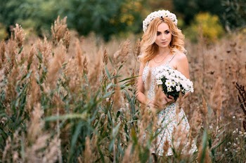 Woman on Field Holding Flowers