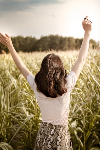 Woman on Grass Field Lifting Hands