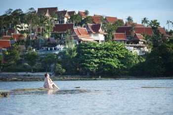 Woman on Rock Beside Body of Water