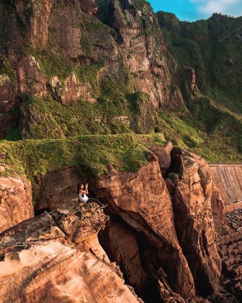 woman on rock formation cliff