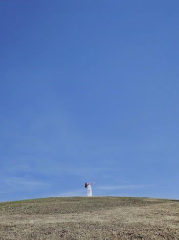 Woman On Top Of Hill