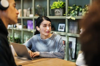 Woman Operating Laptop on Table
