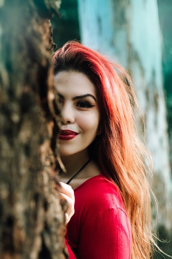 Woman Peeking Behind Wall