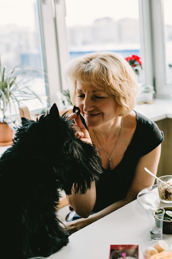 Woman Playing a Black Dog