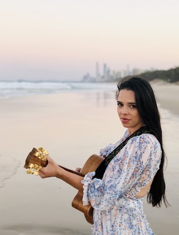 Woman Playing Acoustic Guitar On Seashore