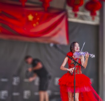 Woman Playing Electric Flying on Stage