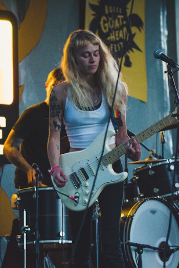 Woman Playing Electric Guitar on Stage
