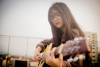 Woman Playing Guitar