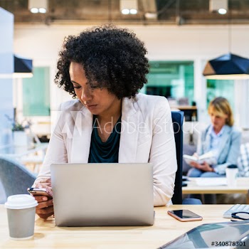 Woman playing on her phone at work