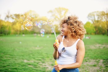 Woman Playing With Soap Bubble 