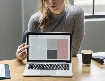 Woman Pointing at Laptop's Screen
