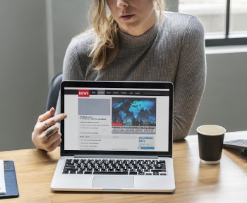 Woman Pointing On Macbook Pro Screen