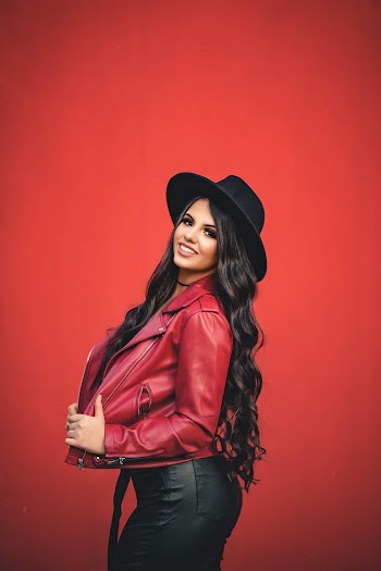 Woman Poses Wearing A Red Jacket